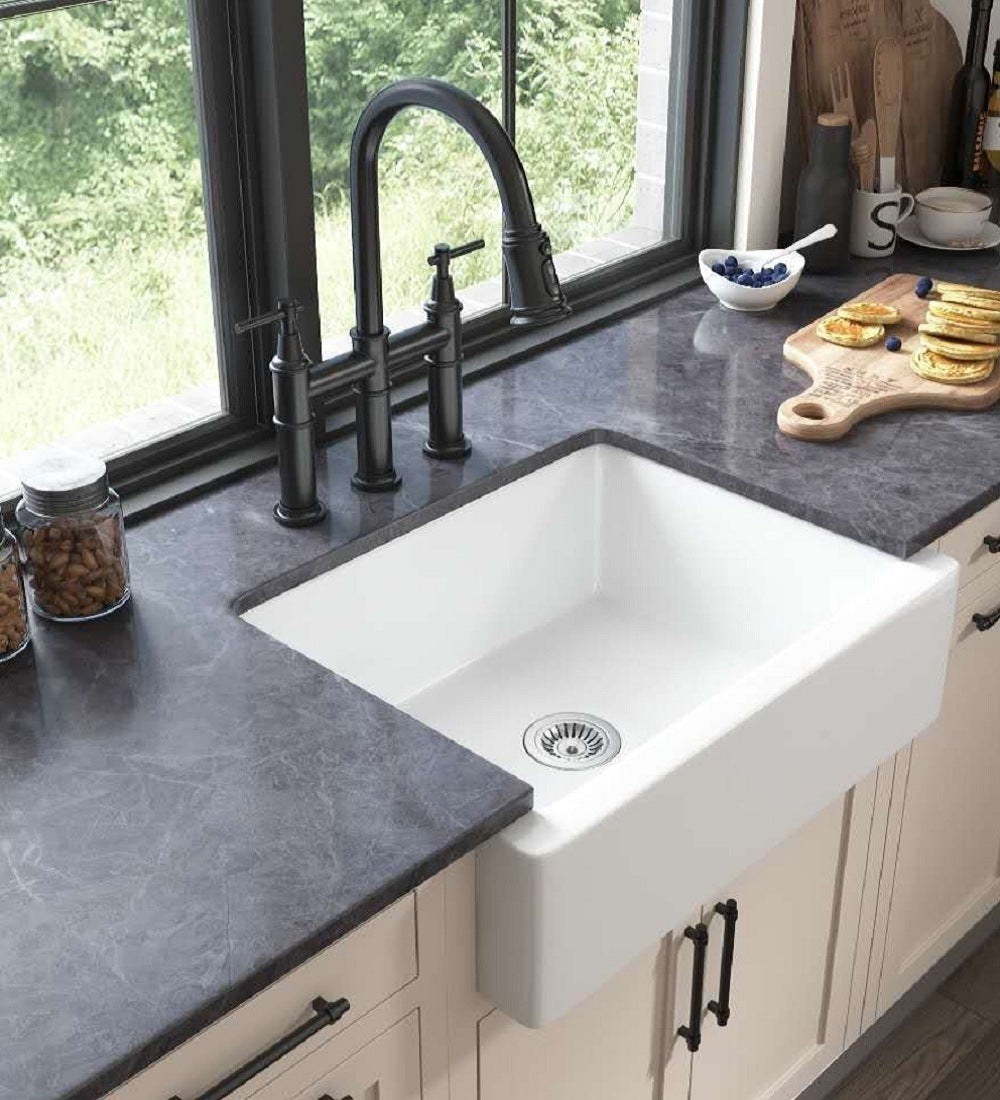 White ceramic kitchen sink in front of farmhouse/apron